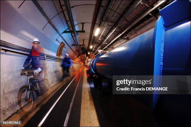 Engineers move about the 27 kilometer LHC tunnel on bicycles. Protons will travel in the circular tunnel at the speed of light. Each proton will...