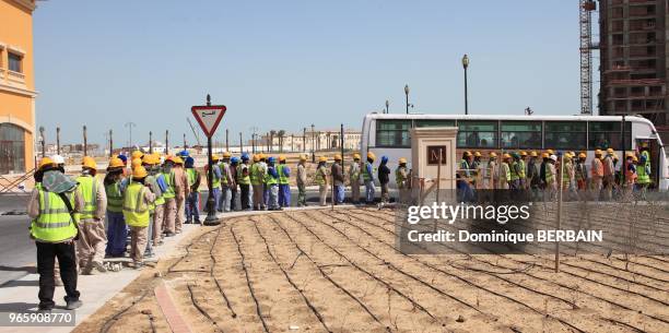 The population of Qatar is mainly composed of migrant workers from Asia. After the workday, workers, very disciplined, return to their camp by bus....