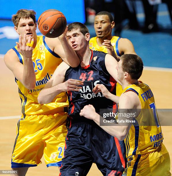 Timofey Mozgov, #25 of BC Khimki Moscow Region and Vitaly Fridzon, #7 of BC Khimki Moscow Region compete with Stanko Barac, #42 of Caja Laboral...