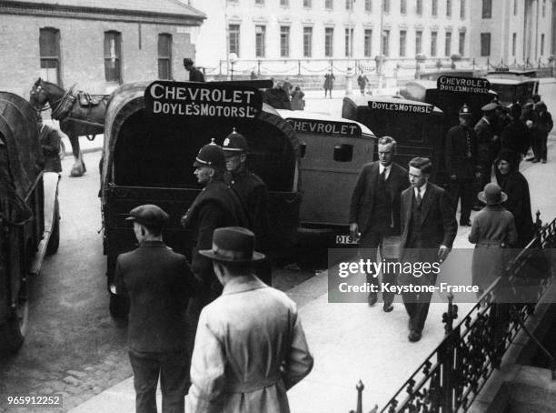 Les boites de bulletins de la grande loterie sont transportées sous bonne escorte par les policiers , à Dublin, Irlande, le 30 mai 1931.