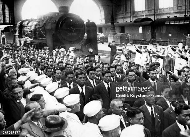 équipe d'athlètes olympiques chinoise est accueillie par des saluts hitlériens lors de son arrivée solennelle à la gare le 23 juillet 1936 à Berlin,...