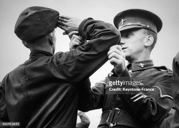 Un milicien, vêtu de son uniforme, photographié à l'entraînement faisant le salut militaire, à la caserne du régiment de Manchester, à...