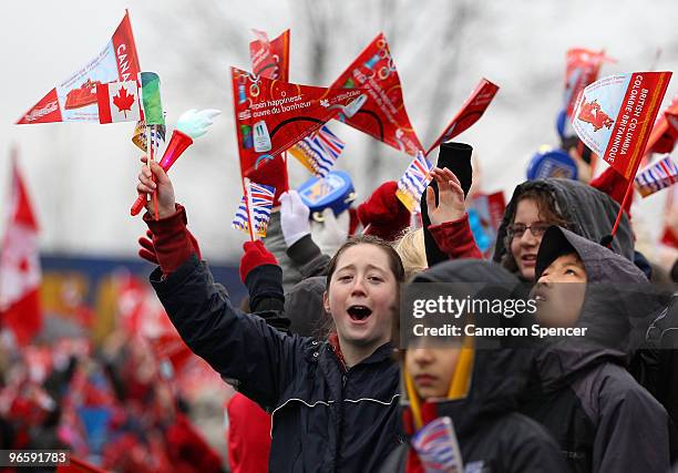 Spectators cheer along the relay route during the Vancouver 2010 Olympic Torch Relay ahead of the Vancouver 2010 Winter Olympics on February 11, 2010...