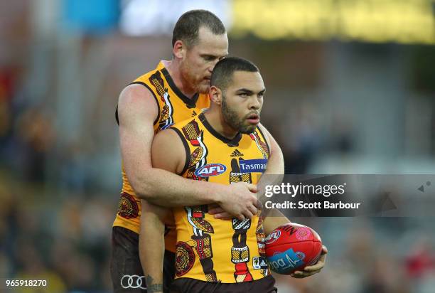 Jarman Impey of the Hawks is congratulated by Jarryd Roughead of the Hawks after marking the ball in the final minutes during the round 11 AFL match...