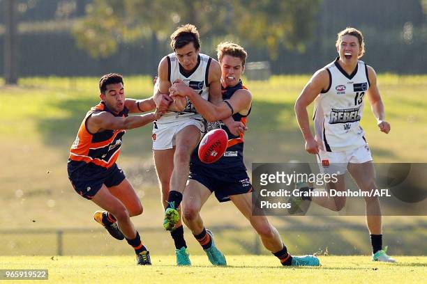 Matthew Lloyd of the Rebels kicks as he is tackled during the round eight TAC Cup match between the Calder Cannons and Greater Western Victoria...