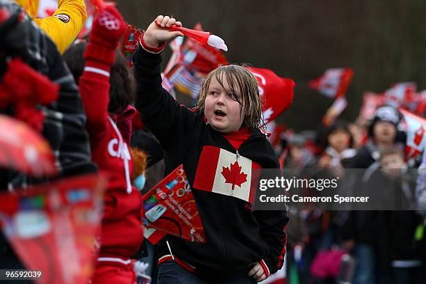 Young spectator cheers along the relay route during the Vancouver 2010 Olympic Torch Relay ahead of the Vancouver 2010 Winter Olympics on February...