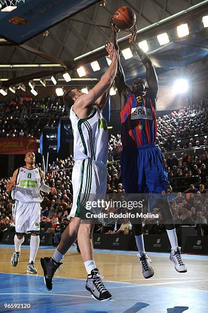 Boniface Ndong, #21 of Regal FC Barcelona competes with Nikola Pekovic, #14 of Panathinaikos Athens during the Euroleague Basketball 2009-2010 Last...