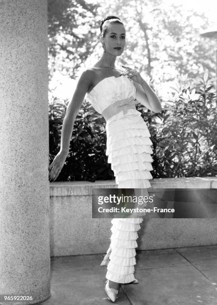 Robe longue de soirée en popeline blanche et ceinture turquoise des Etablissements Boussac de la Collection Printemps/Eté 1959, lors de la...