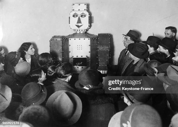 Robot électrique installé dans un grand magasin qui répond aux questions que lui pose le public et peut dire la bonne aventure, à Londres,...