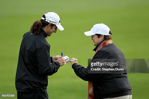 Musician Kenny G signs an autograph on the second hole during the first round of the AT&T Pebble Beach National Pro-Am at Pebble Beach Golf Links on...