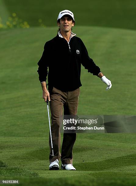 Musician Kenny G follows his shot on the sixth hole during the first round of the AT&T Pebble Beach National Pro-Am at Pebble Beach Golf Links on...