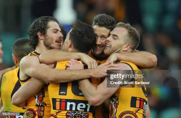 Tom Mitchell of the Hawks and Isaac Smith of the Hawks celebrate at the final siren during the round 11 AFL match between the Hawthorn Hawks and the...