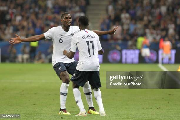 Ousmane Dembl celebrates after scoring with Paul Pogba during the friendly football match between France and Italy at Allianz Riviera stadium on June...