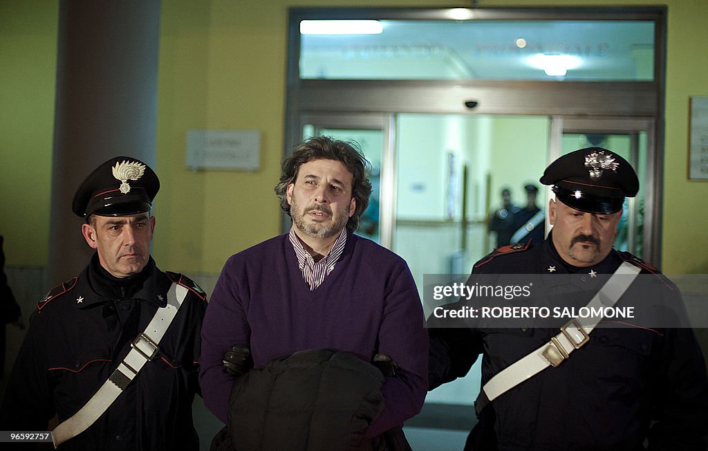 Corrado De Luca (C) is seen on his arres