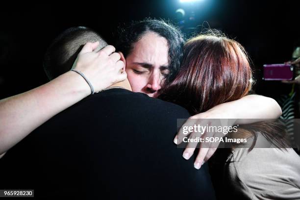 Political prisoner seen hugging her relatives after being released. Political prisoners reunite with relatives after being released from prison with...