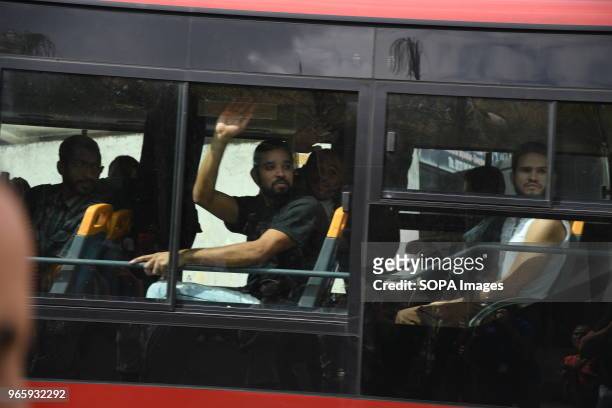 Political prisoners wave at their relatives outside Helicoide in Caracas as they were being put on the bus to leave from the prison. The Government...