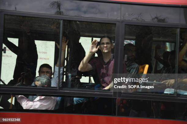 Political prisoners wave at their relatives outside Helicoide in Caracas as they were being put on the bus to leave from the prison. The Government...