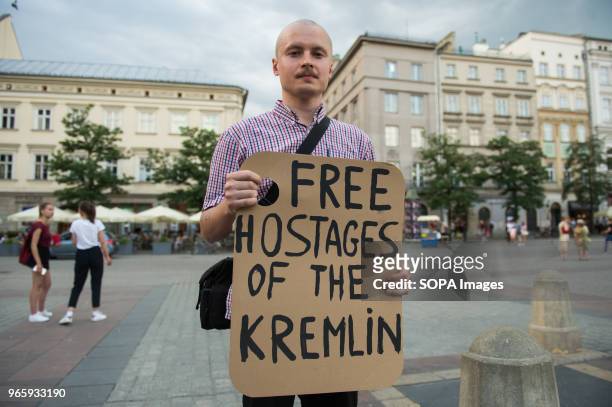 Man holds a banner saying "Free hostages of the Kremilin" during a protest demanding the release of the Ukrainian filmmaker and writer,Oleg Sentsov...