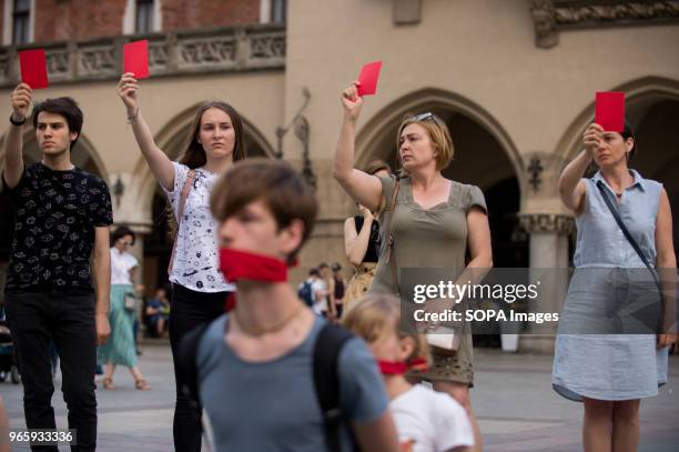 Ukrainians hold red cards during a protest demanding the release of the Ukrainian filmmaker and writer,Oleg Sentsov at the Main Square in Krakow....