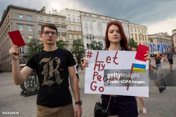 Ukrainians hold red cards during a protest demanding the release of the Ukrainian filmmaker and writer,Oleg Sentsov at the Main Square in Krakow....