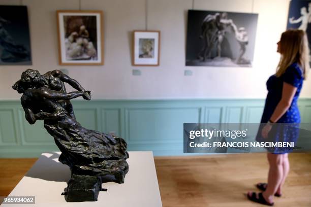 Person stands next to the "Waltz" by the artist Camille Claudel as she visits the Claudel's family house, on June 1, 2018 in Villeneuve-sur-Fere,...