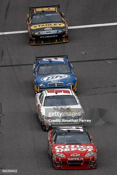 Tony Stewart, driver of the Old Spice/Office Depot Chevrolet, leads Kasey Kahne, driver of the Budweiser Ford, Kurt Busch, driver of the Miller Lite...