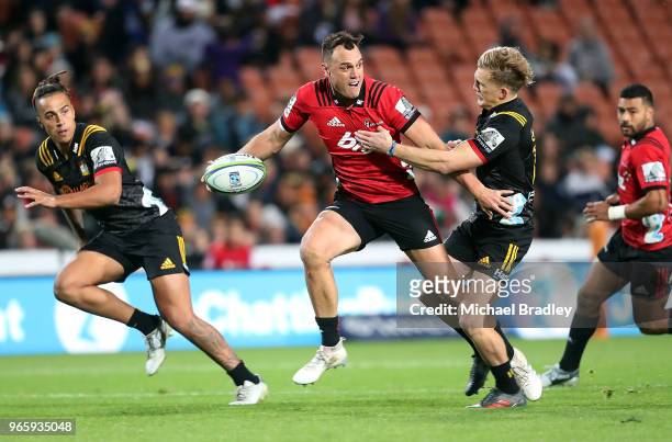Crusaders fullback Israel Dagg is tackled by Chiefs Damian McKenzie during the round 16 Super Rugby match between the Chiefs and the Crusaders at...