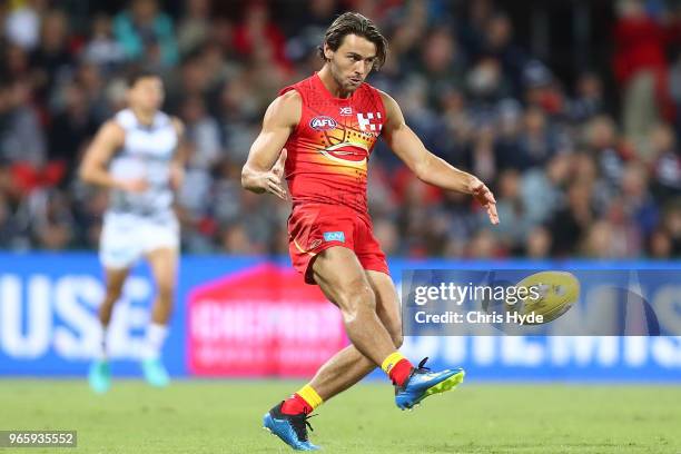 Lachie Weller of the Suns kicks during the round 11 AFL match between the Gold Coast Suns and the Geelong Cats at Metricon Stadium on June 2, 2018 in...