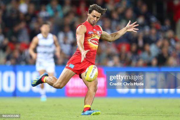 Lachie Weller of the Suns kicks during the round 11 AFL match between the Gold Coast Suns and the Geelong Cats at Metricon Stadium on June 2, 2018 in...