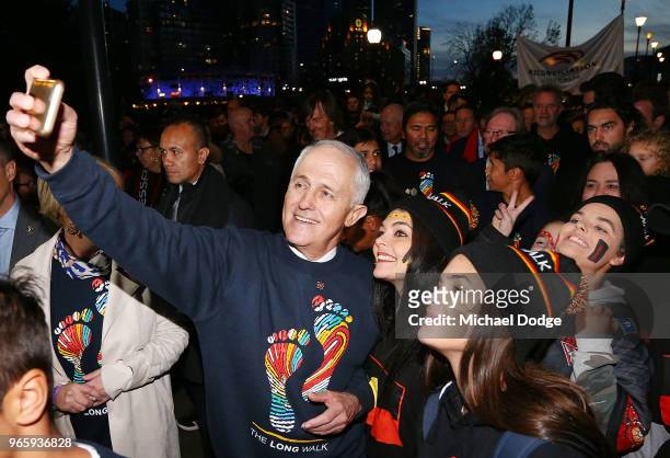 Prime Minister Malcom Turnbull poses with footy fans during The Long Walk before during the round 11 AFL match between the Essendon Bombers and the...