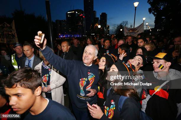 Prime Minister Malcom Turnbull walks with footy fans during The Long Walk before during the round 11 AFL match between the Essendon Bombers and the...