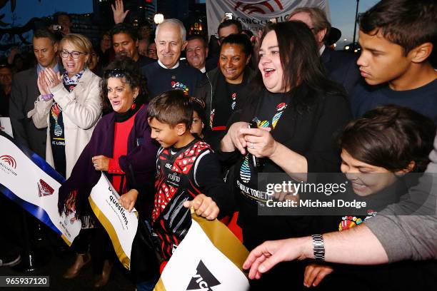 Prime Minister Malcom Turnbull walks with footy fans during The Long Walk before during the round 11 AFL match between the Essendon Bombers and the...
