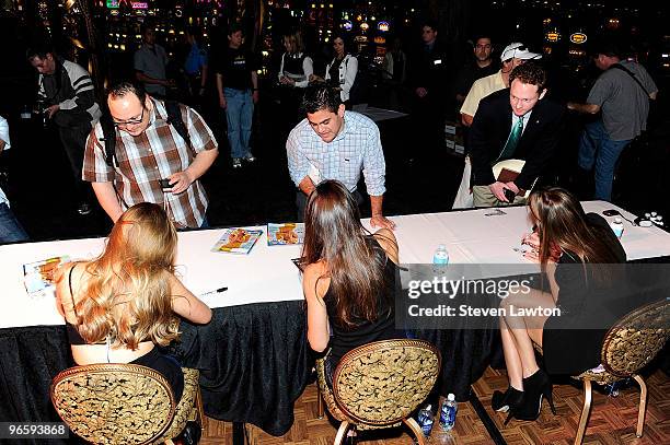 Sports Illustrated swimsuit models Esti Ginzburg, Zoe Duchesne and Dominique Piek signing Sports Illustrated magazines for fans at the Paris Las...