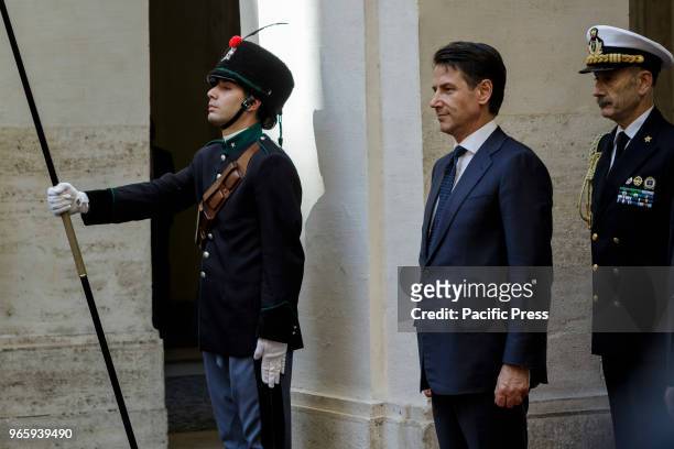 Newly appointed Italys Prime Minister Giuseppe Conte reviews a guard of honor upon his arrival at Chigi Palace for the bell ceremony.