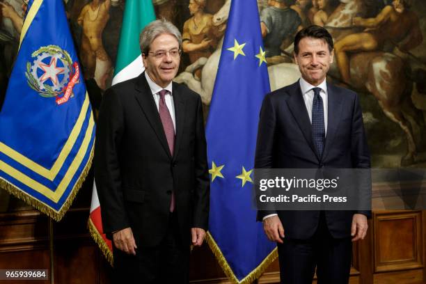 New Italian Prime Minister Giuseppe Conte receives a silver bell from former Prime Minister Paolo Gentiloni during the bell ceremony, to signify the...