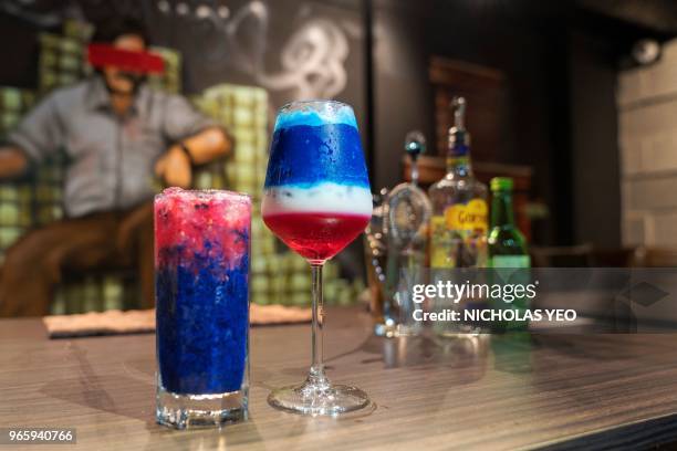 This picture taken on June 1, 2018 shows the US President Donald Trump and North Korean leader Kim Jong Un themed cocktails at a bar in Singapore....