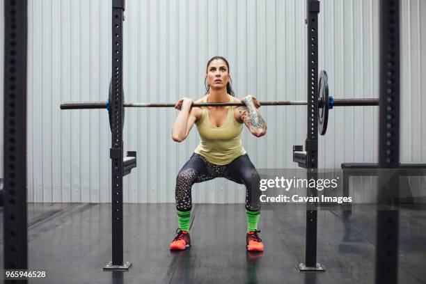 confident woman lifting deadlift in gym - deadlift stock pictures, royalty-free photos & images