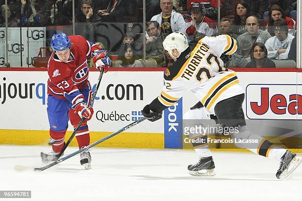 Ryan White of Montreal Canadiens takes a shot in front of Shawn Thornton of Boston Bruins during the NHL game on February 7, 2010 at the Bell Centre...