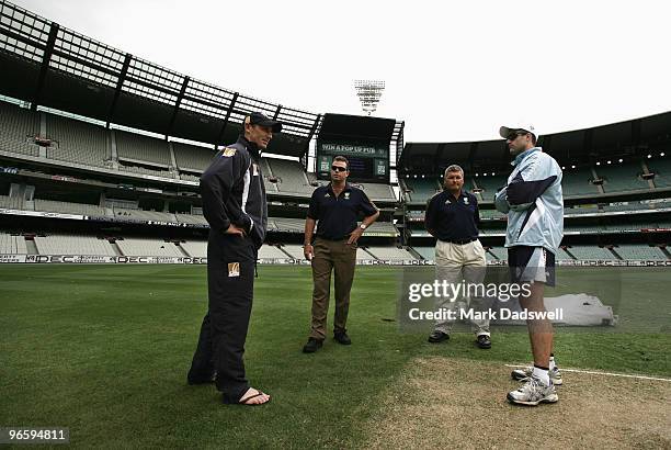Bushrangers captian David Hussey and Blues captain Simon Katich Blues discuss the starting time with Umpires Marais Erasmus and Mick Martell during...