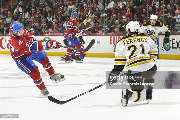 Ryan White of Montreal Canadiens takes a shot in front of Andrew Ference of Boston Bruins during the NHL game on February 7, 2010 at the Bell Centre...