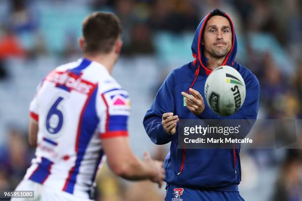 Mitchell Pearce of the Knights passes to Connor Watson of the Knights during warm up before the round 13 NRL match between the Parramatta Eels and...