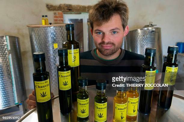 Marien Sablery, an agricultor cultivating organic hemp on 25 hectares, poses with products made with hemp in Evaux les Bains, Creuse region, on May...