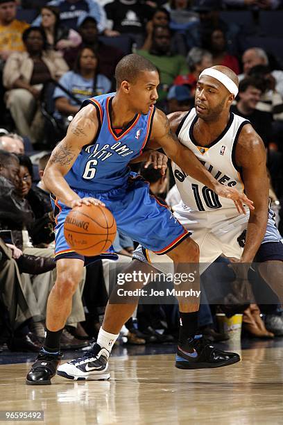 Eric Maynor of the Oklahoma City Thunder moves the ball up court against Jamaal Tinsley of the Memphis Grizzlies during the game at the FedExForum on...