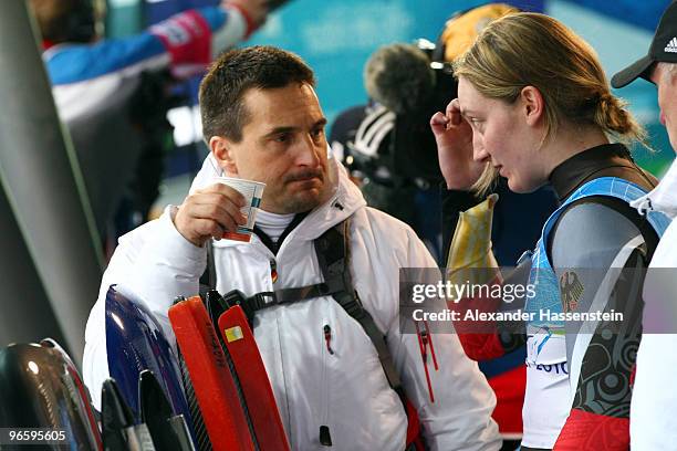 Georg Hackl, national team coach of Germany talks to Tatjana Huefner during the Women's Singles Luge training run at the Whistler Sliding Centre...