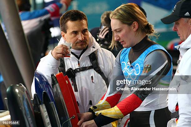 Georg Hackl, national team coach of Germany talks to Tatjana Huefner during the Women's Singles Luge training run at the Whistler Sliding Centre...