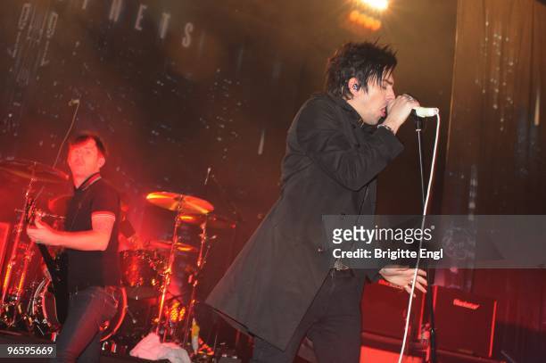 Mike Lewis and Ian Watkins of Lostprophets perform on stage at Brixton Academy on February 11, 2010 in London, England.