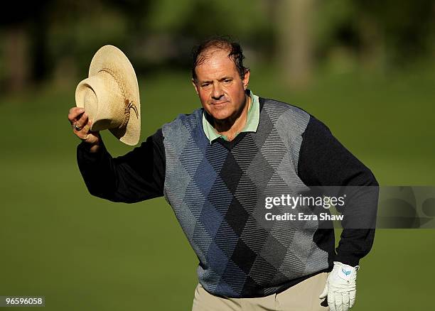 Chris Berman tips his hat before finishing on the ninth hole during the first round of the AT&T Pebble Beach National Pro-Am at at the Spyglass Hill...