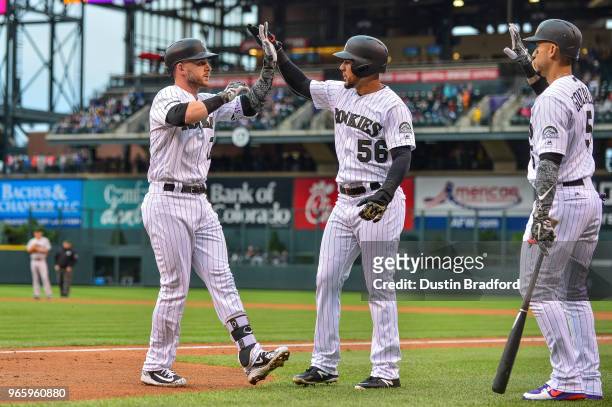 Trevor Story of the Colorado Rockies celebrates with Noel Cuevas after hitting a first inning 3-run homerun against the San Francisco Giants at Coors...