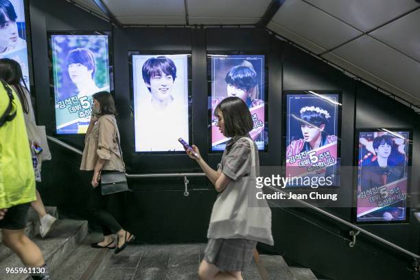 Photos of Jin from BTS are displayed at Sinchon Subway Station put up by approximately 80 fans to celebrate Jin's 5th anniversary of his debut with...
