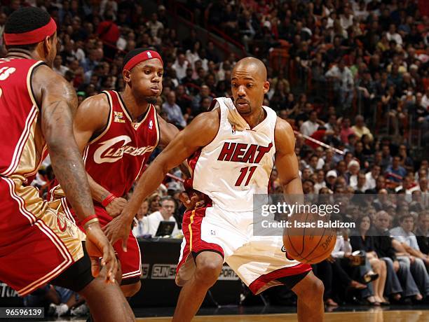 Rafer Alston of the Miami Heat makes a move with the ball against Rafer Alston and LeBron James of the Cleveland Cavaliers during the game at...